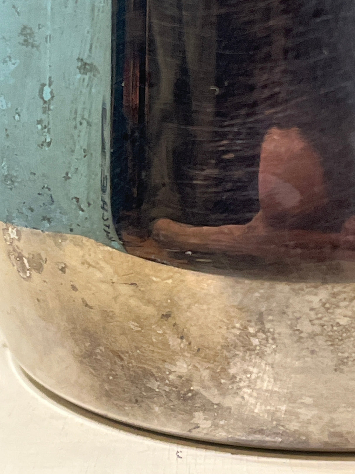 Ilsa Turbo Express 6-Cup 18/10 stainless steel stovetop espresso pot on tarnished metal; reflects photographer's finger, showcasing its sturdy, elegant design.