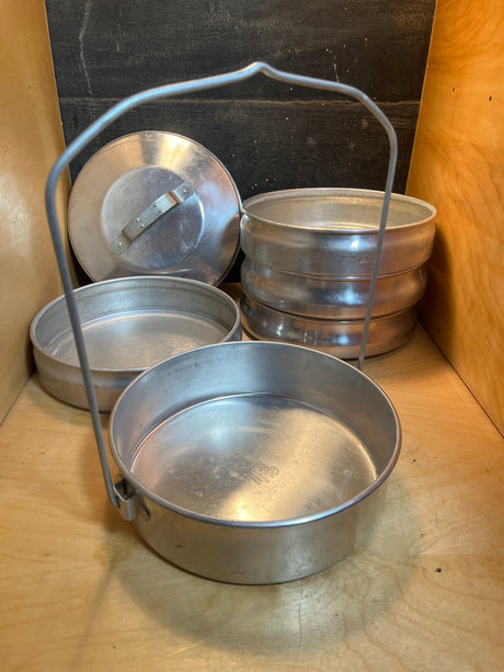 Stackable 5-tier food storage container - vintage aluminum Buckeye by Mardigian Corp., shown with folding wire-bail handle and loose lid, ideal for organizing meals.