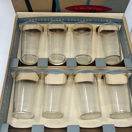 Ten-piece Beverage Set of clear glass tumblers in original box, featuring a pair of glasses, a glass container with metal handle, and a glass with silver handle. Ideal for everyday and special occasions.