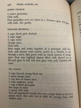 Trader Vic’s Bartender’s Guide (Revised 1972) open to page 328, showcasing recipes for Queen Charlie, Rhubarb Highball, and Tea Punch with preparation steps.