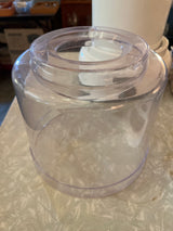 Transparent bowl component of the Automatic Ice Cream Maker - Hamilton Beach 68880, showcasing the empty cylindrical reservoir with a circular feed-tube opening on a countertop.