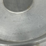 Close-up of cake pan with a circle design, ideal for bundt or angel food cakes. Engraved letters say "Made in USA - Patents Pending." From Spoons Kitchen Exchange.