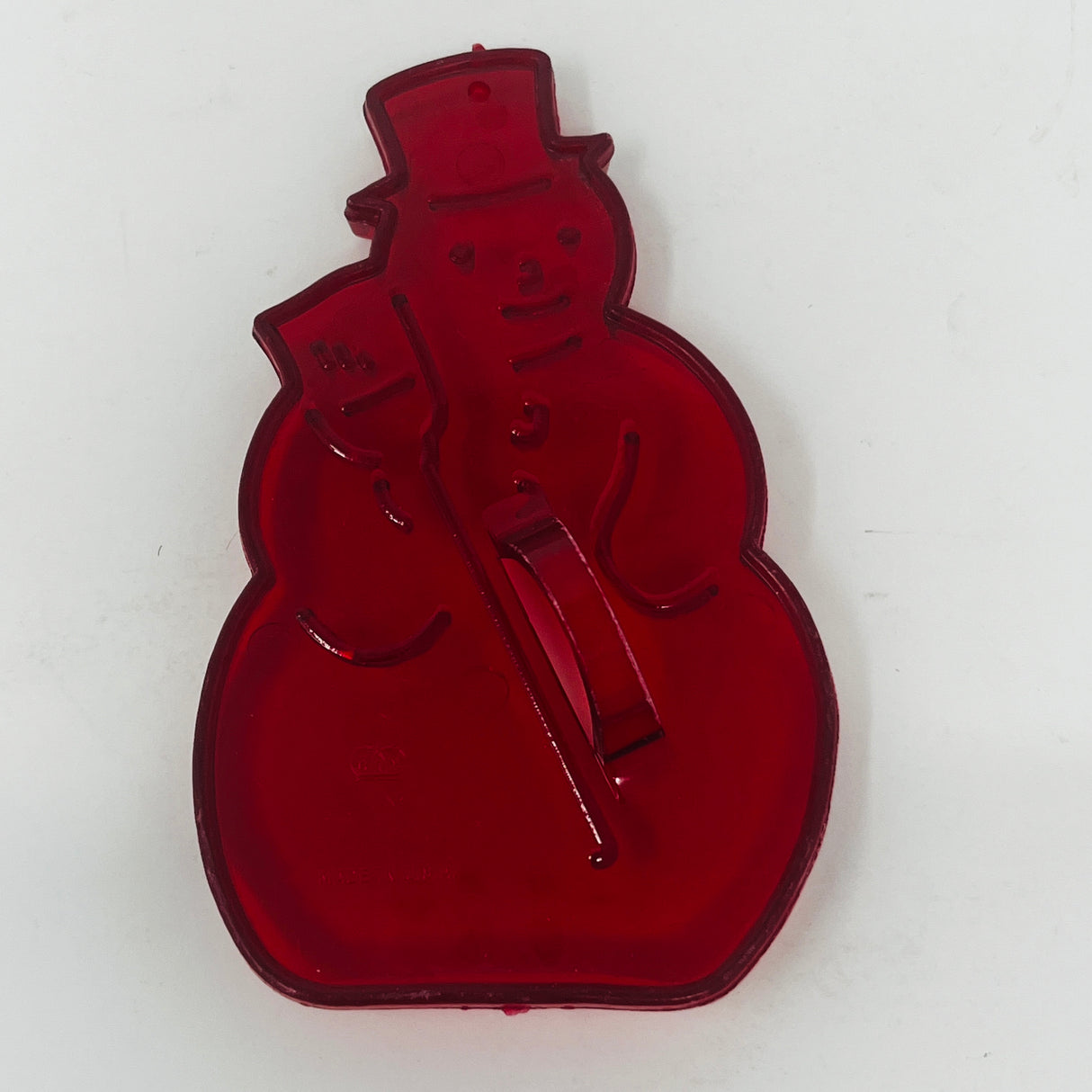 Red plastic mid century cookie cutters, including a snowman shape and other unique designs.