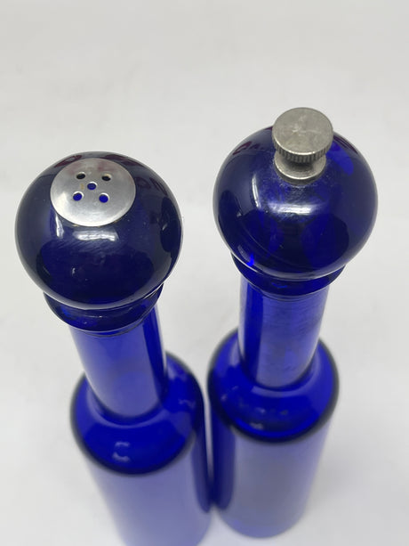 Cobalt blue Olde Thompson salt shaker and pepper grinder set with silver tops, featuring translucent lucite material and a carbon steel grinder. 