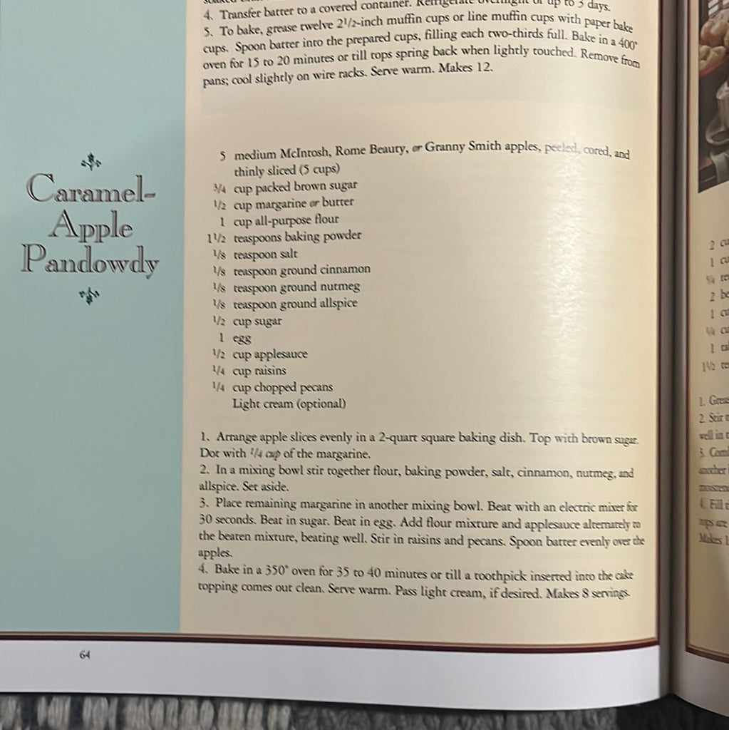 A close-up of A Festive Christmas recipe book with holiday recipes and tablesetting ideas. Recipe for Caramel-Apple Pandowy. From Spoons Kitchen Exchange.