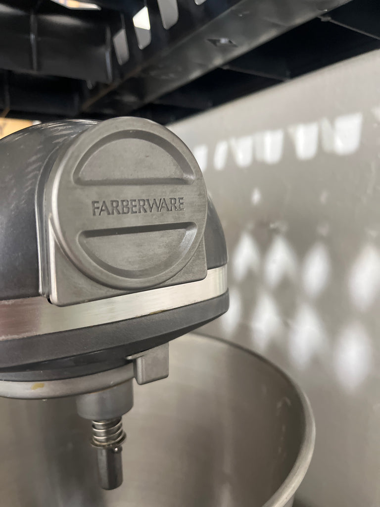 Farberware 6-speed professional mixer with durable metal bowl and three paddle attachments, ideal for home bakers seeking efficiency and reliability.