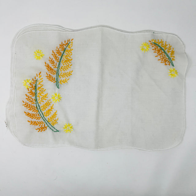 Hand-embroidered floral napkins set of 4 with delicate flower and sun motifs in white linen blend fabric. From Spoons Kitchen Exchange. 