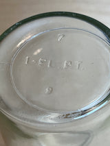 Anchor Hocking narrow glass jelly jar close-up showing embossed 1 FL. PT. markings, with mold numbers 7 and 9 visible, indicating capacity and manufacturing details.