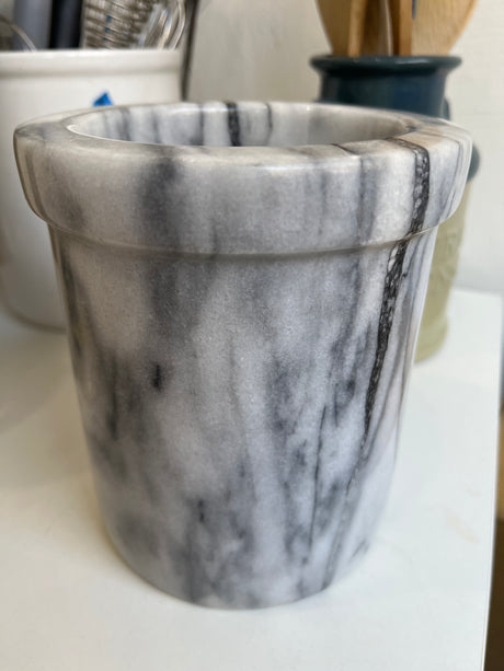 Marble kitchen utensil crock on a counter, showcasing a sturdy design with a white and grey marbled pattern. Ideal for organizing kitchen tools.