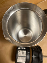 Espro French press with a brushed-metal carafe and black plastic plunger/filter assembly, viewed from above, showcasing its sleek, stainless-steel interior design.