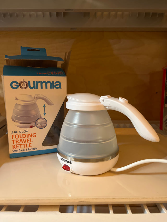 Gourmia folding travel kettle with a silicone base and stainless steel heating element, designed to boil up to 0.6 qt of water quickly.