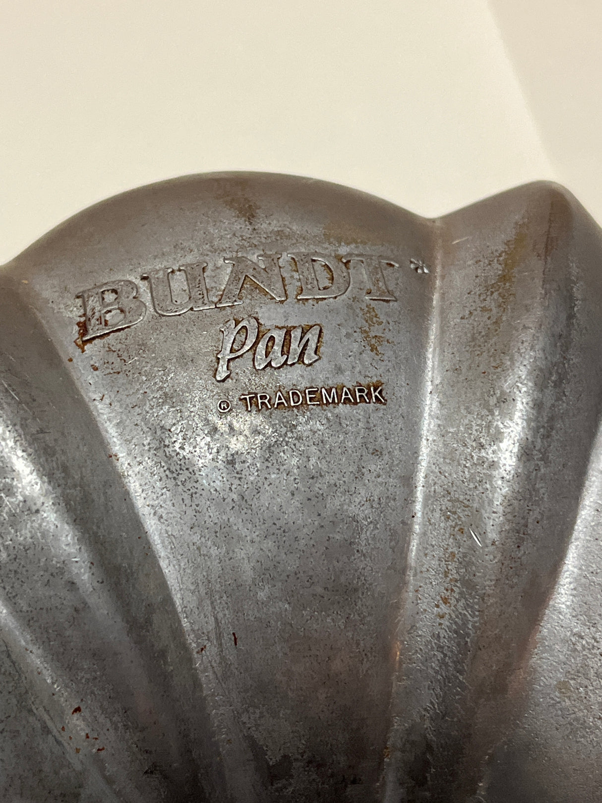 Northland Aluminum Products Inc., Original Bundt Cake pan, showcasing its fluted underside with Bundt Pan ® Trademark marking, highlighting its vintage 1950s heavy-duty aluminum craftsmanship.