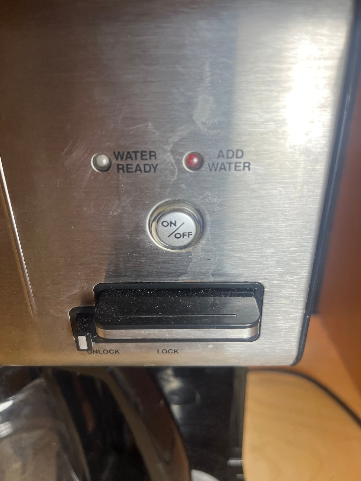 12-cup Cuisinart coffee maker panel with “WATER READY” and “ADD WATER” LEDs, ON/OFF button, and UNLOCK/LOCK latch for brew head, ensuring user-friendly operation.