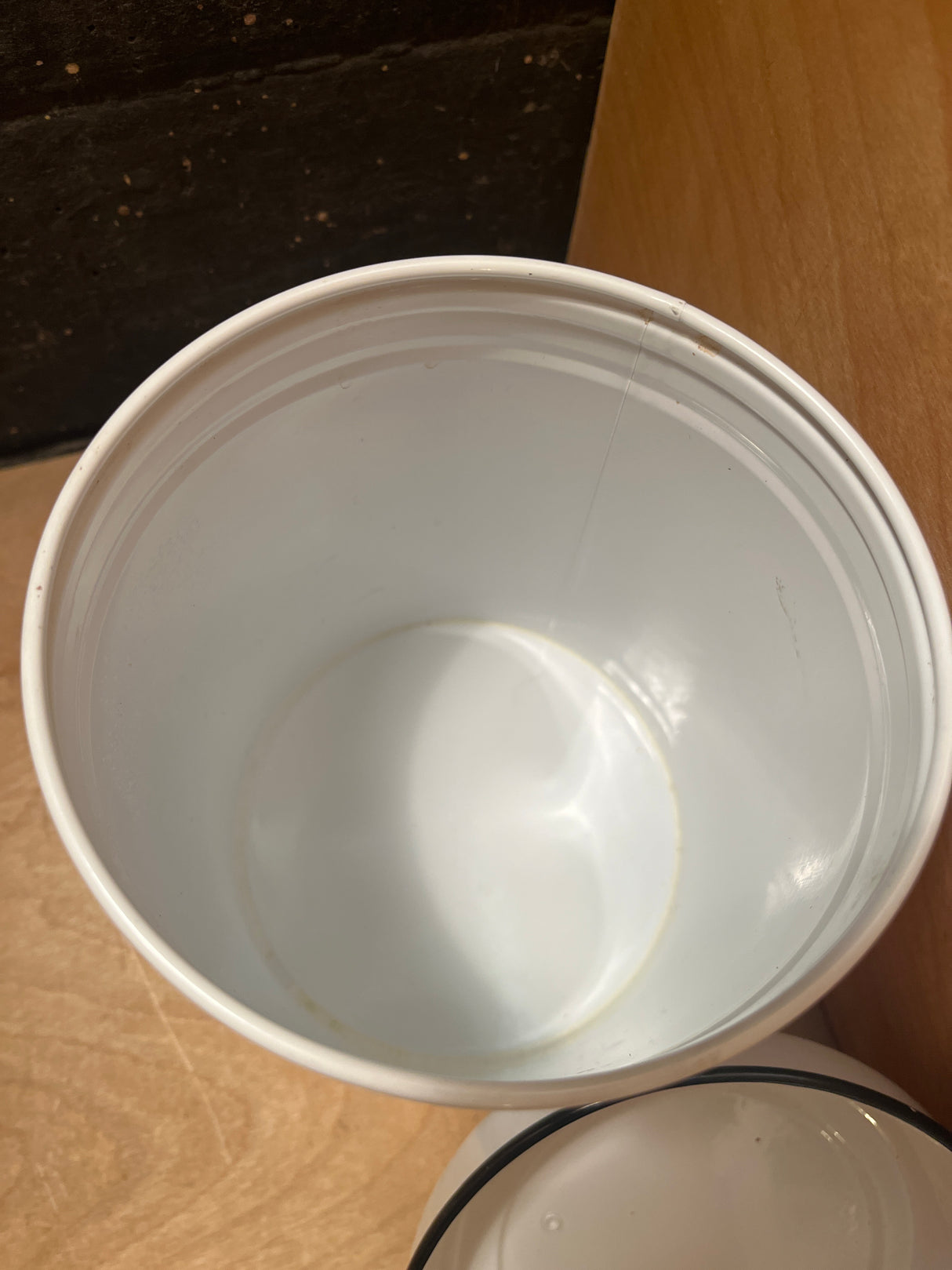 Old Sheffield Village Country Family Cottage Biscuits tin, a plain white tub with lid, sits empty on wood surface, adding vintage charm to your kitchen.