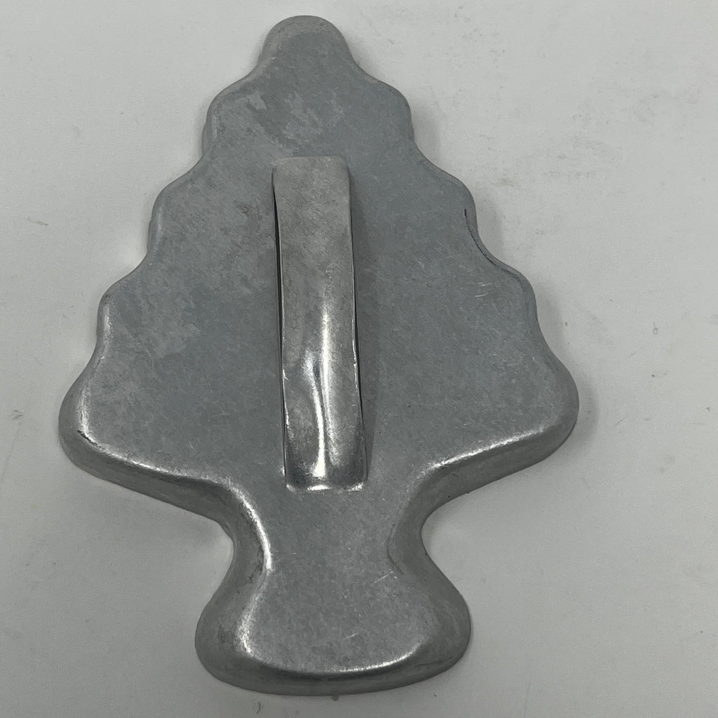 Mid century metal cookie cutter with long handle, featuring various shapes like moons and stars.