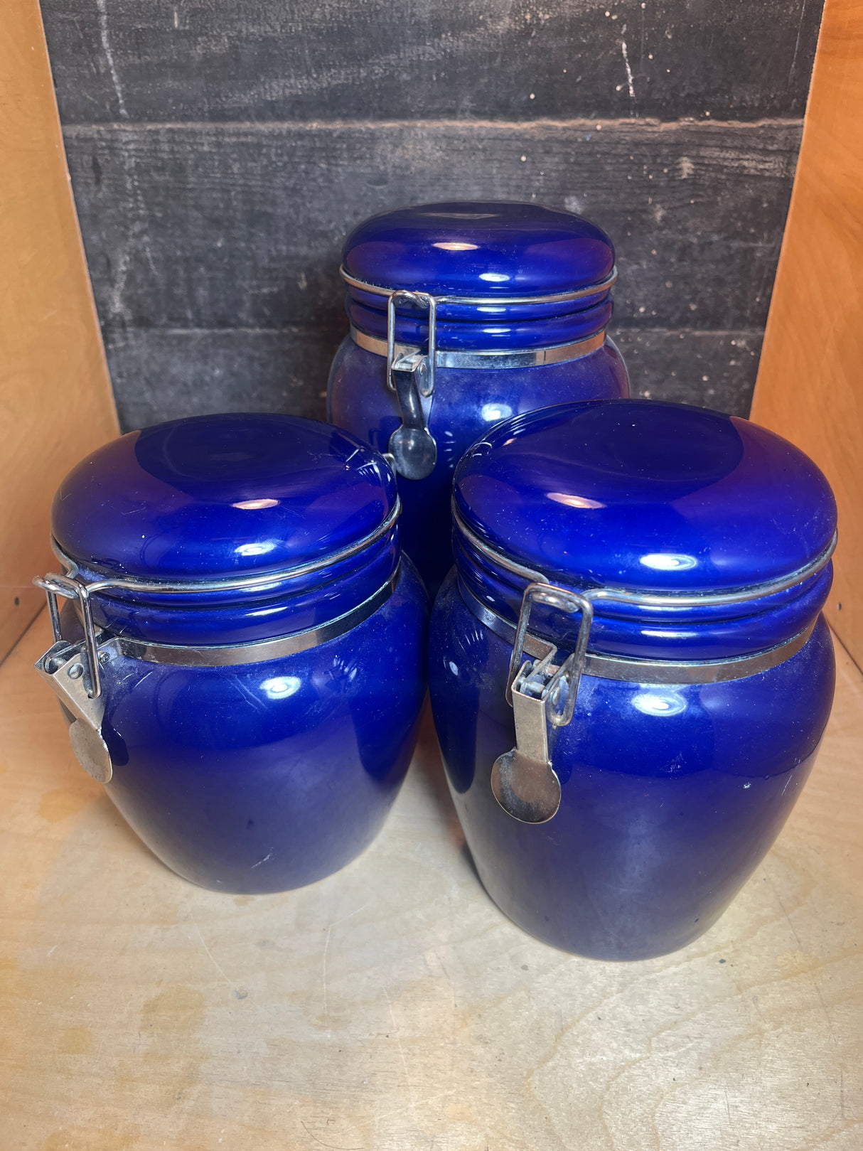 Set of 3 jars - cobalt blue ceramic with locking lids, ideal for storing coffee and tea, combining functional airtight seals with stylish kitchen decor.