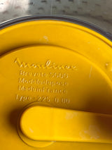 Close-up of a yellow lid from a Moulinex Spinner kitchen appliance, featuring embossed details including brand name, model number, and Made in France.
