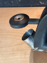 Whistling tea kettle - Kitchenaid 2 quart, stainless steel with black handle, showing close-up of spout with open black lever cap.