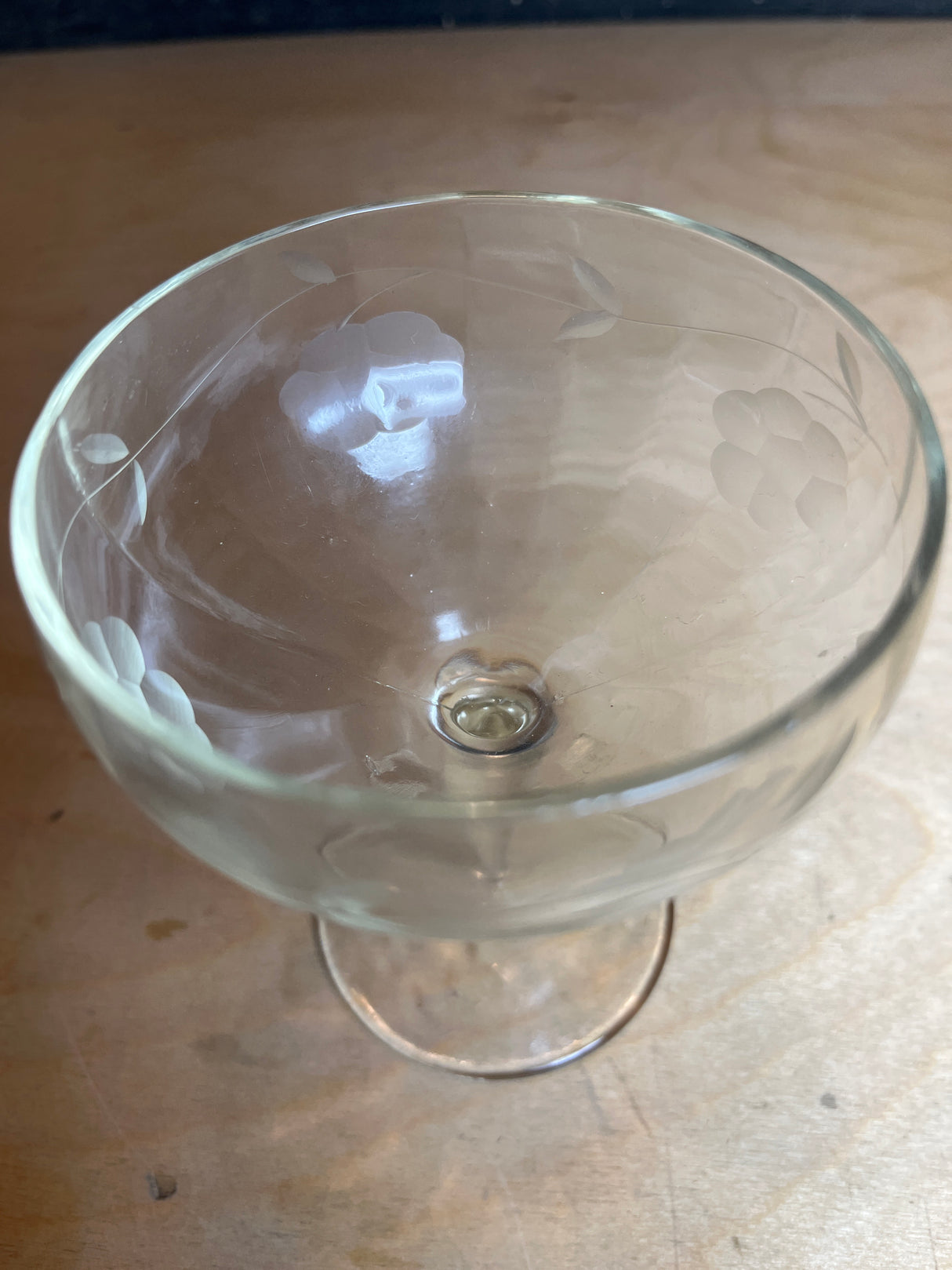 Princess House Heritage Pattern etched glass wine goblet, featuring a wide, shallow bowl with elegant floral etching around the rim, mounted on a slender stem.