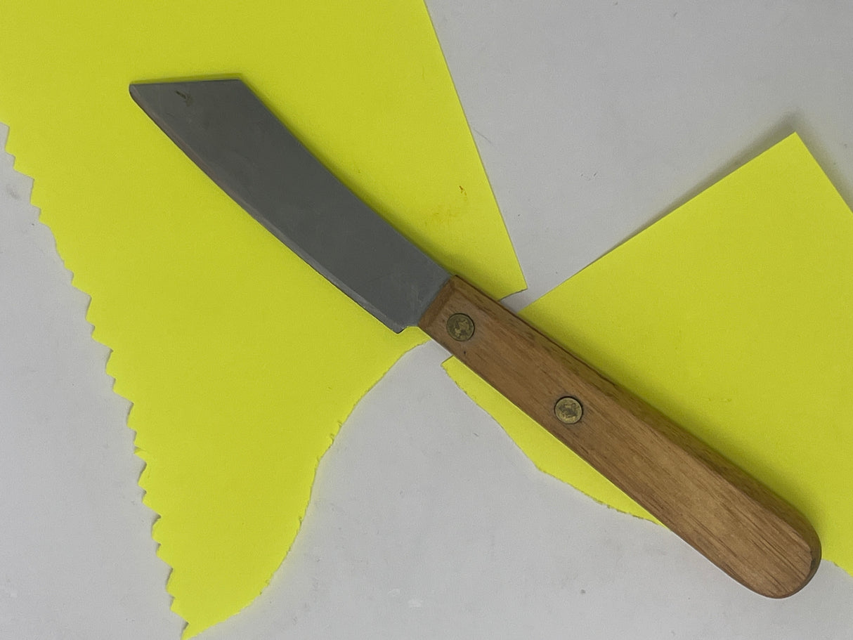 Little stainless utility knife with wood handle, featuring a compact, cleaver-like shape, ideal for delicate tasks like slicing chilis.