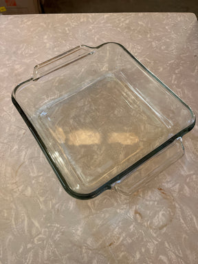 Casserole dish square 2 quart/2 liter - Anchor Hocking Basics with clear glass, built-in handles, shallow sides, ideal for baking, on a countertop.