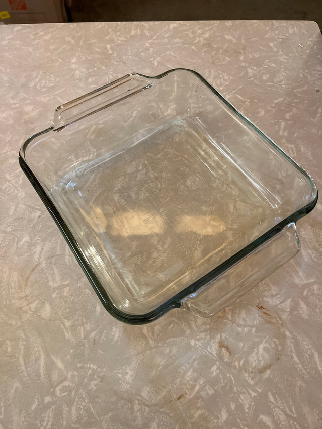 Casserole dish square 2 quart/2 liter - Anchor Hocking Basics with clear glass, built-in handles, shallow sides, ideal for baking, on a countertop.