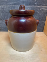 Vintage two-toned ceramic pot with lid, featuring a rich brown glazed top and natural off-white base, ideal for storing dry pantry goods on countertops.