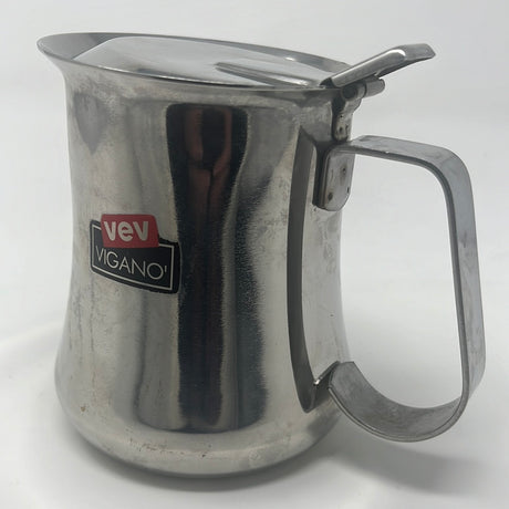 A stainless steel milk frothing pitcher with a handle, ideal for Italian coffee lovers, holds 18 oz.