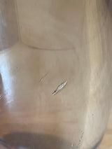 Close-up of a stemless hard acrylic wine glass interior showing two elongated gouges, revealing a lighter material beneath the scratched surface.