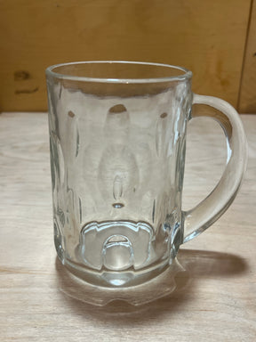 Anchor Hocking vintage clear thumbprint dimple glass mug featuring a fluted, dimpled design, sturdy handle, and soft shadow on a wooden surface.