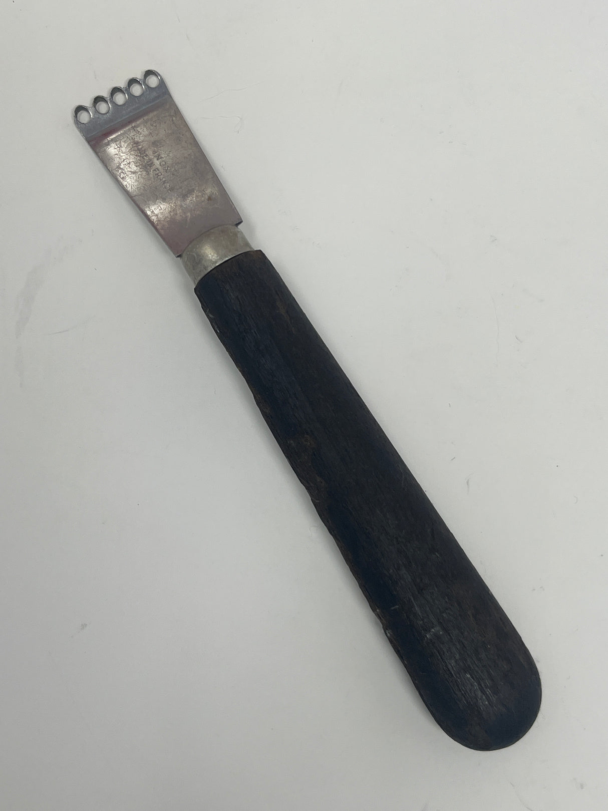 Econome vintage French zester with a sharp metal blade and wooden handle, showing minor wear on the black handle, in excellent working condition.