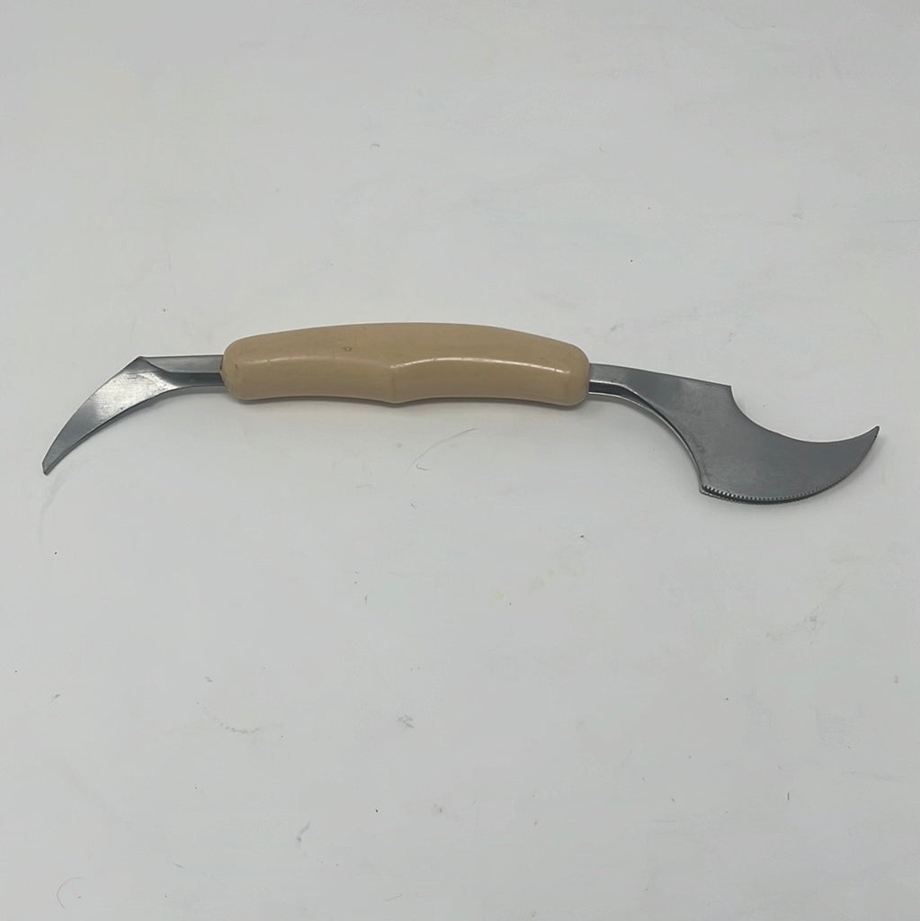 A Japanese 18-8 grapefruit knife and segment separator with cream handle, featuring sharp metal edges for precise fruit cutting.