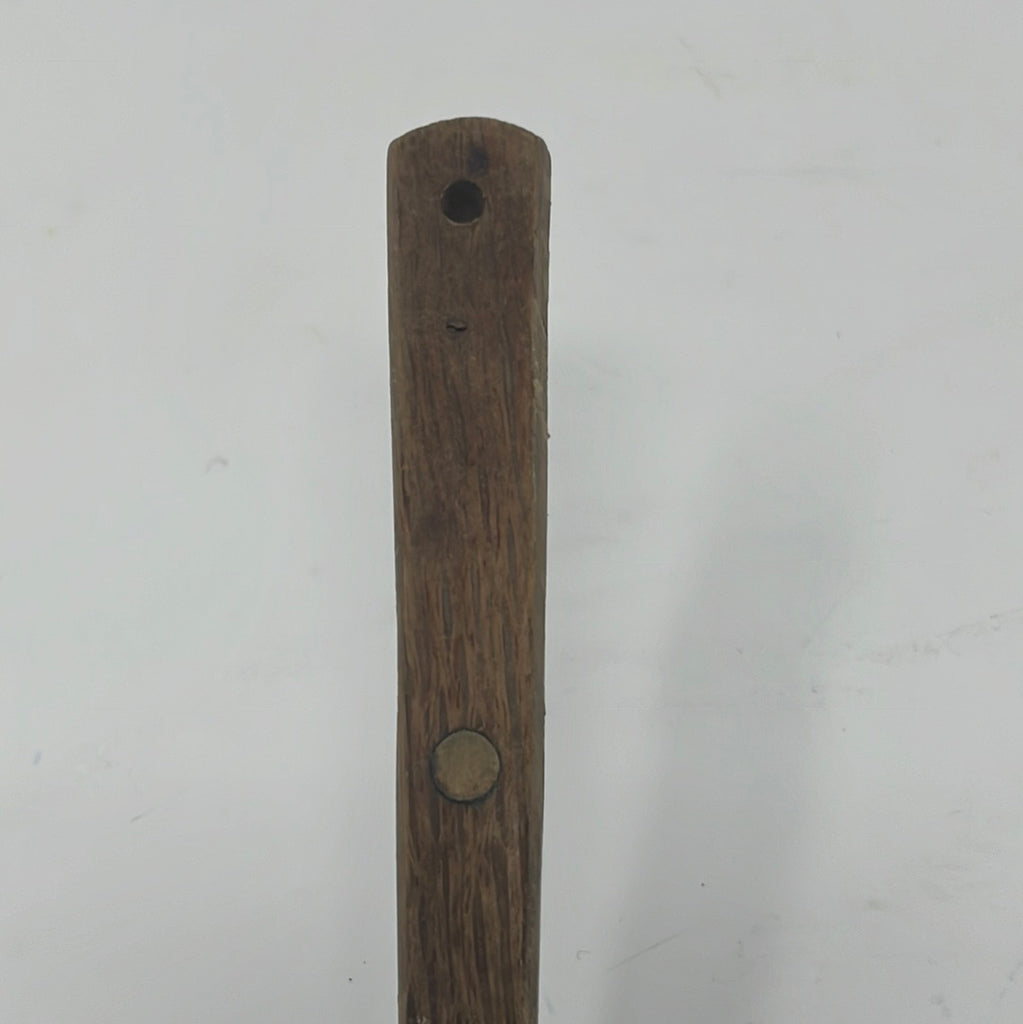 Closeup of oval slotted spatula's wooden handle. From Spoons Kitchen Exchange.