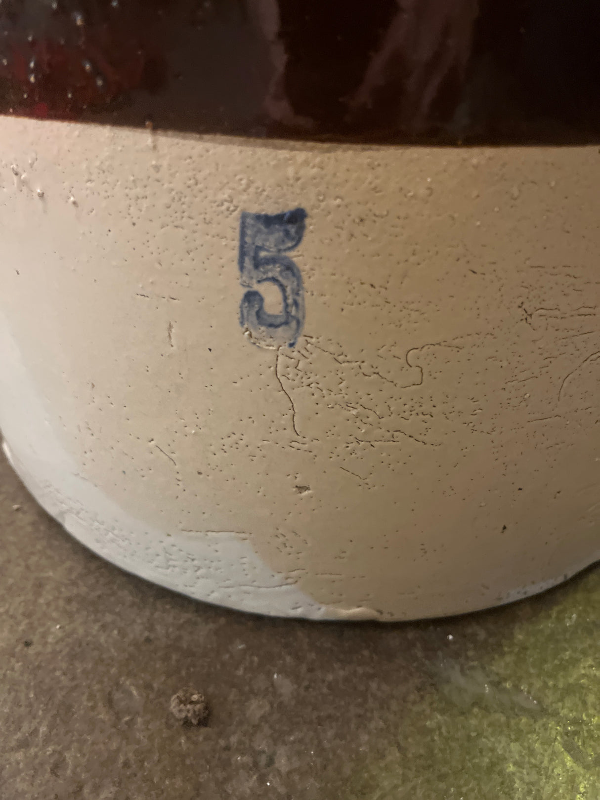 Antique 5 gallon stoneware ceramic pickling crock with stamped blue 5, featuring visible pock-marks in the glaze, in excellent condition without chips or cracks.