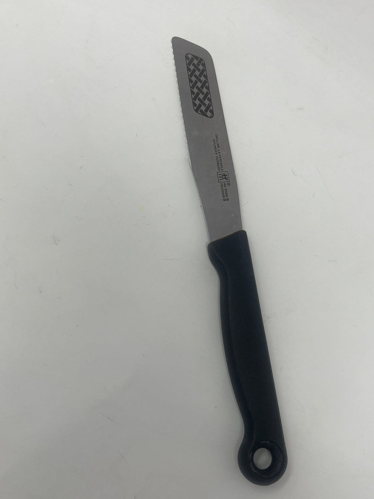 Vintage Zwilling J.A. Henckels serrated butter knife with black handle, ideal for easily cutting spreads and crafting butter curls.