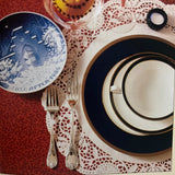 A Festive Christmas: Holiday Recipes and Tablesetting Ideas book displayed with a porcelain platter, highlighting festive culinary and decor inspirations from Better Homes and Gardens.