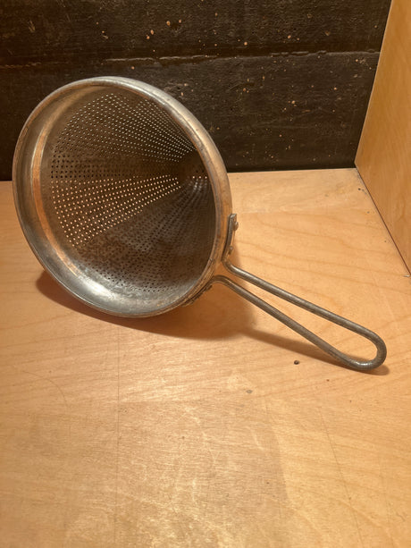 Cone sieve strainer - stainless steel vintage, featuring a conical, perforated bowl with a long looped handle, ideal for sifting dry ingredients or straining liquids.