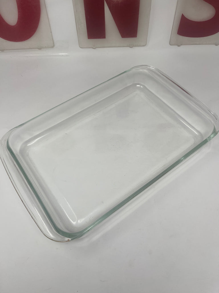 PYREX Corning 233-N rectangular glass baking dish on a white surface.