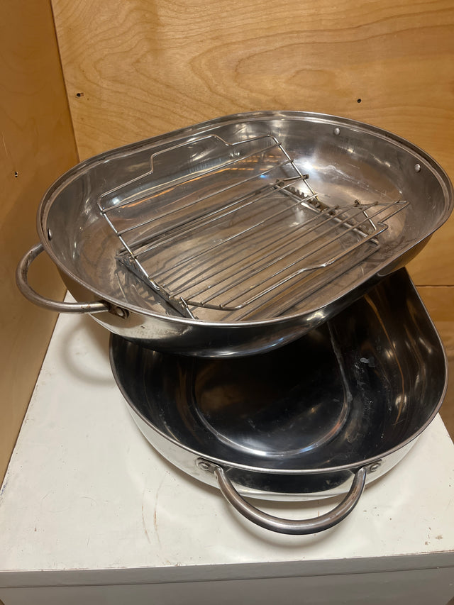 Stainless steel oval roasting pan with rack and lid, featuring two stacked pans with looped handles and a top pan equipped with a removable rack.