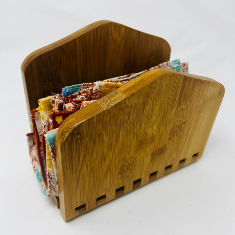 Adjustable bamboo napkin holder with wooden box and fabric detail. From Spoons Kitchen Exchange. 