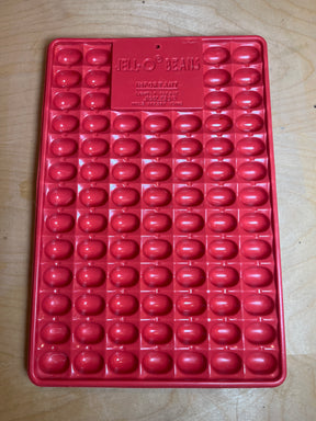 Jell-O Jiggler vintage mold in red plastic, designed to create 82 small bean-shaped gelatin treats or jelly shots, featuring multiple bean-shaped cavities.