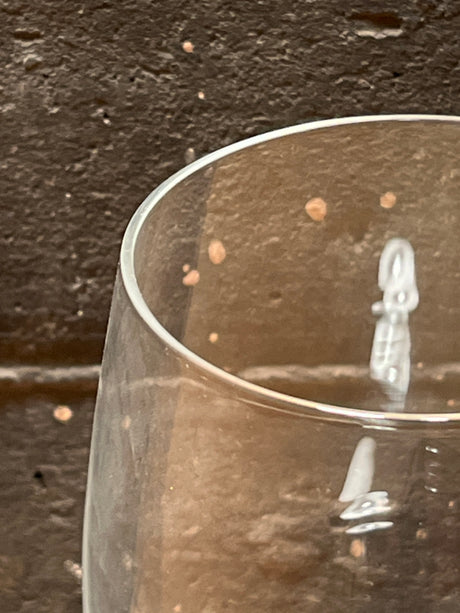 Close-up of a Crystal Water Goblet from the Isabelle line by Bohemia Crystal-Crystalex, showcasing its clear glass with a subtle logo against a textured background.