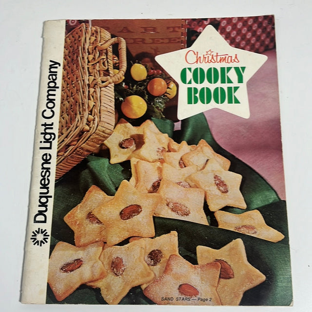 Front cover of the Christmas Cooky Book with festive treats - a book, cookies, and pastries for a delightful holiday season. From Spoons Kitchen Exchange.