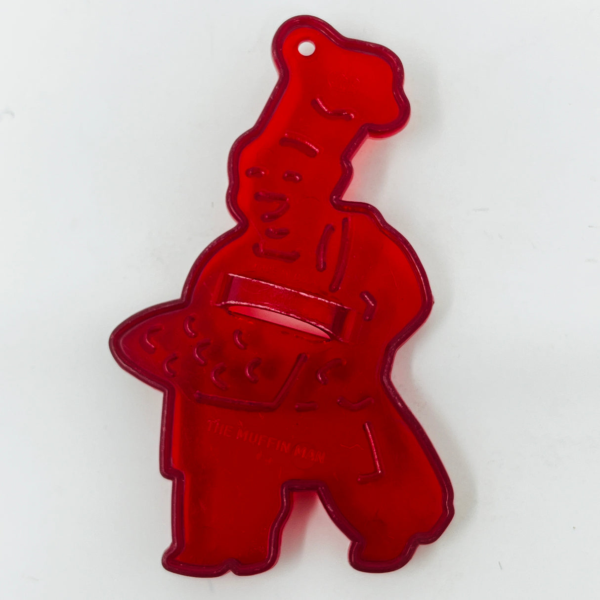 Red plastic mid century cookie cutters, some with Crown logo, on a white surface.