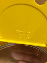 Close-up of a yellow lid embossed with Semco on a Gemco sugar and cream dispenser, showcasing its classic design and U.S. craftsmanship.