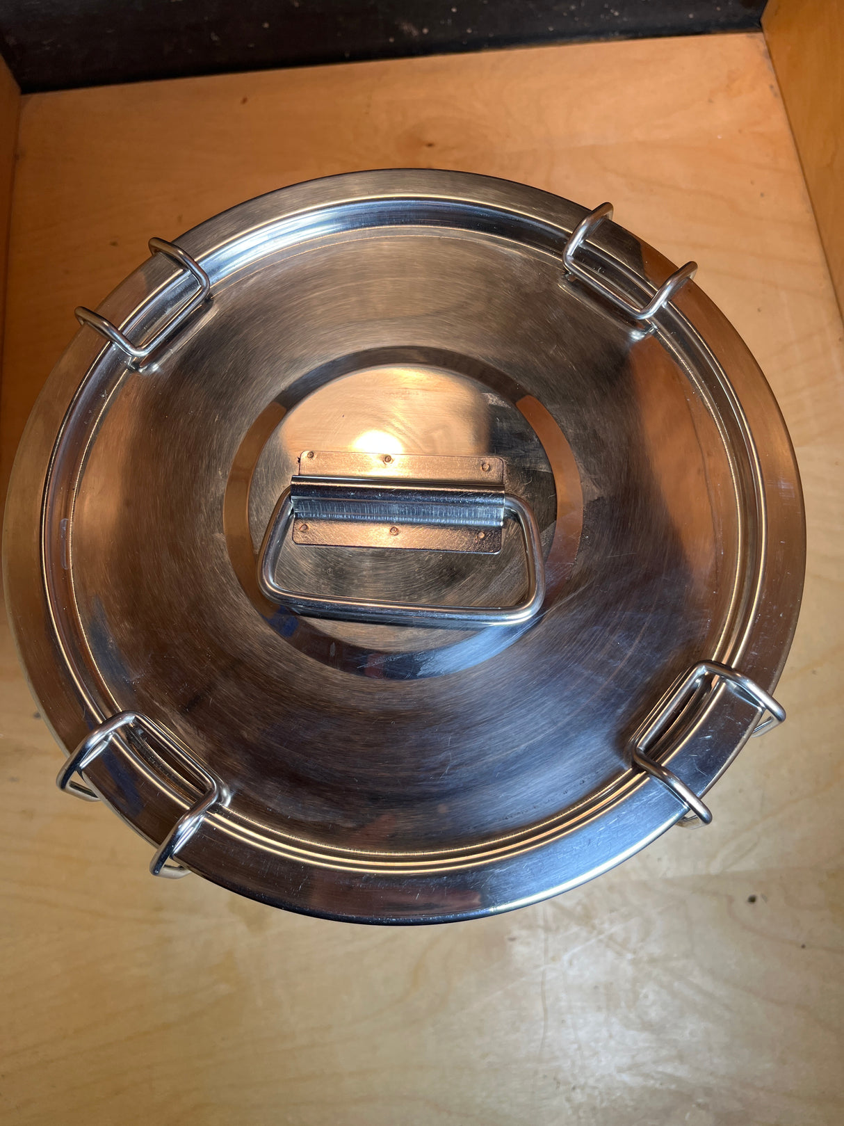 Stainless steel food storage container with clasps, handle, and silicone seal features a clamp-down lid with spring latches, ensuring freshness and secure storage.