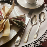 A Festive Christmas: Holiday Recipes and Tablesetting Ideas book displayed with a plate, silverware, and a cup, emphasizing culinary and table-setting inspiration.