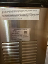 Portable countertop ice maker - Hamilton Beach, showing rear labels with instructions and specifications, including ETL certification, model PIM-1-1, and power details.