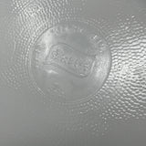 Close-up of Glasbake casserole dish underside showing engraved logo. From Spoons Kitchen Exchange. 