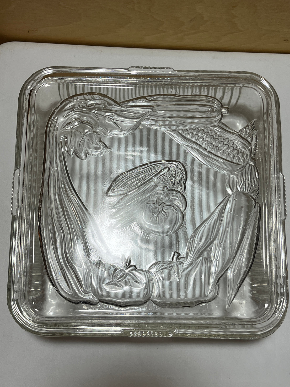 Antique Federal Glass square food container with lid embossed with produce illustrations and grooved sides for grip, from the 1940s.